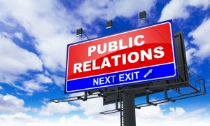 Public Relations - Red Billboard on Sky Background. Business Concept.